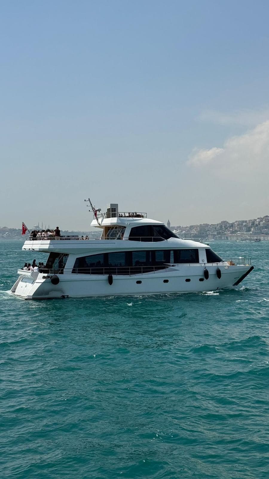 A Vesper yacht under way on the Bosphorus with guests on the upper deck