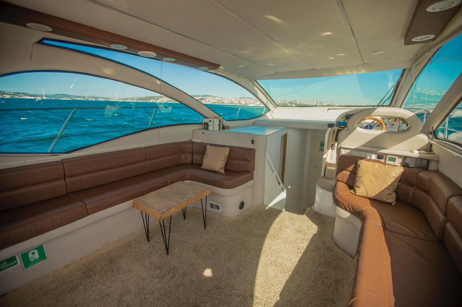 Bow sunpad of a private yacht with a cruise ship and the Bosphorus ahead